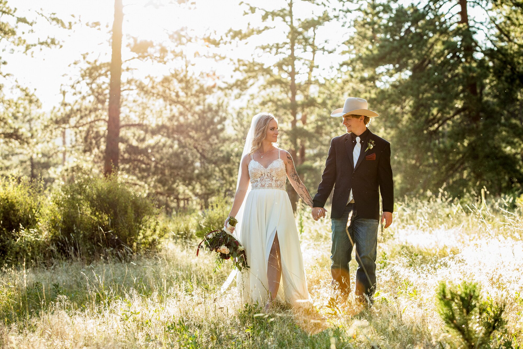 Couple walking through a mountain meadow